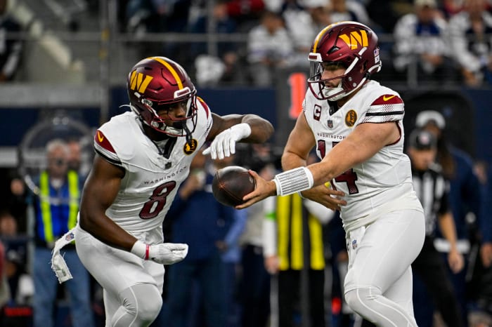 Washington Commanders running back Brian Robinson Jr. (8) and quarterback Sam Howell (14) in action during the game between the Dallas Cowboys and the Washington Commanders at AT&T Stadium.